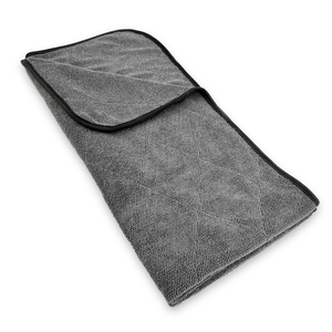 Folded grey microfiber towel on a white background