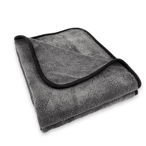 Folded grey microfiber cloth with black border on a white background