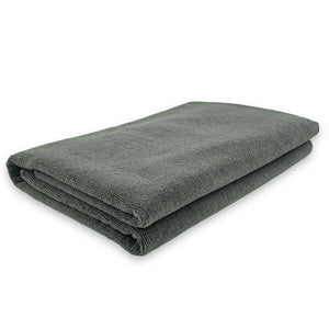 A folded grey microfibre massage towel.