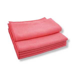 A stack of pink pearl knit microfibre cloths on a white background