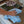 A blue plush microfibre cloth being used to wipe a table in a home