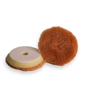 A tan wool buffing pad with a yellow backing foam, designed for car detailing and paint correction.