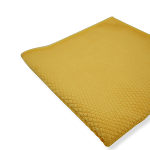 Yellow textured pillow on a white background