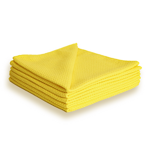 A stack of yellow waffle weave microfibre cloths.