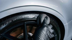 Detailer applying tire dressing to glossy black tire wall using ADBL FOAMBURGER