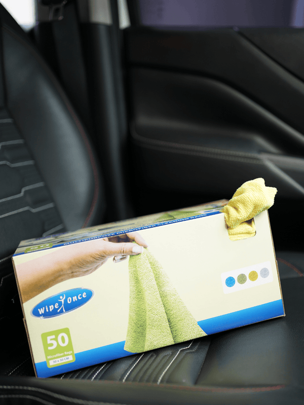 Box of Wipe Once cloths with a yellow cloth on a car seat
