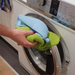 A blue and green waffle weave cloth put into washing machine