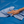 Hand holding a blue microfibre cloth on a blue surface