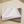 Two folded microfibre glass cloths, one white and one grey, on a marble surface.