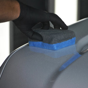 a ceramic coating applicator being used on a car