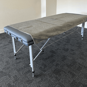 A massage towel layed across a massage bed 
