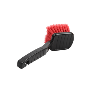 A black-handled tyre brush with red nylon bristles.