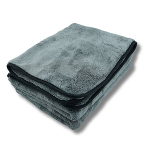 Folded gray towel with black border on a white background