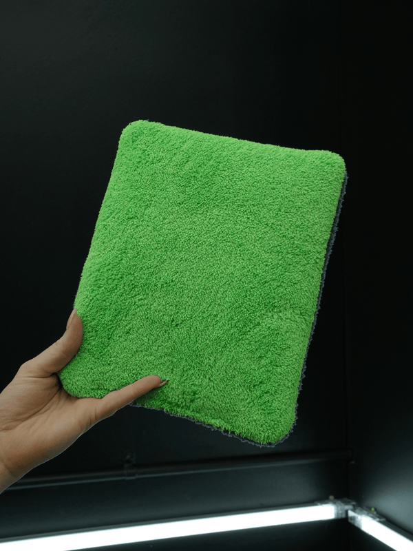 two tone microfibre wash pad held against a black background