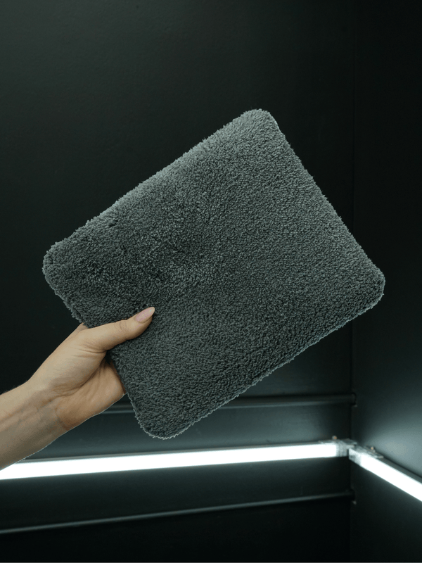 two tone microfibre wash pad held against a black background