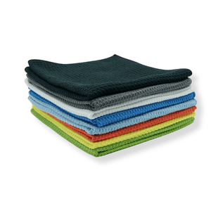 A stack of colourful waffle microfibre cloths on a white background