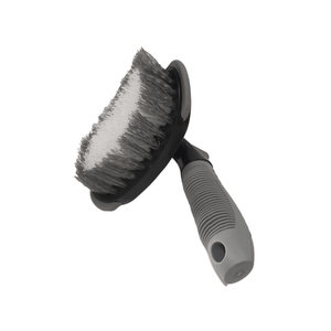 Ergonomic tyre brush with a black and grey handle and white nylon bristles designed for cleaning vehicle tyres.
